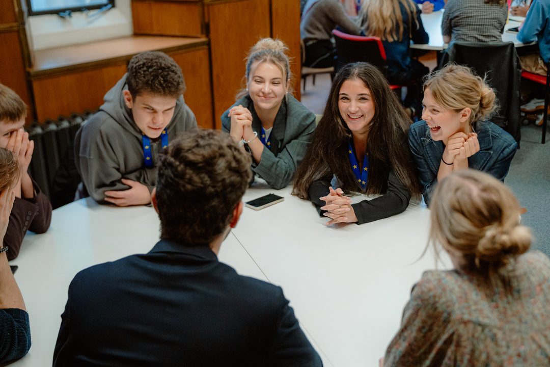 Delegates in discussion around a table