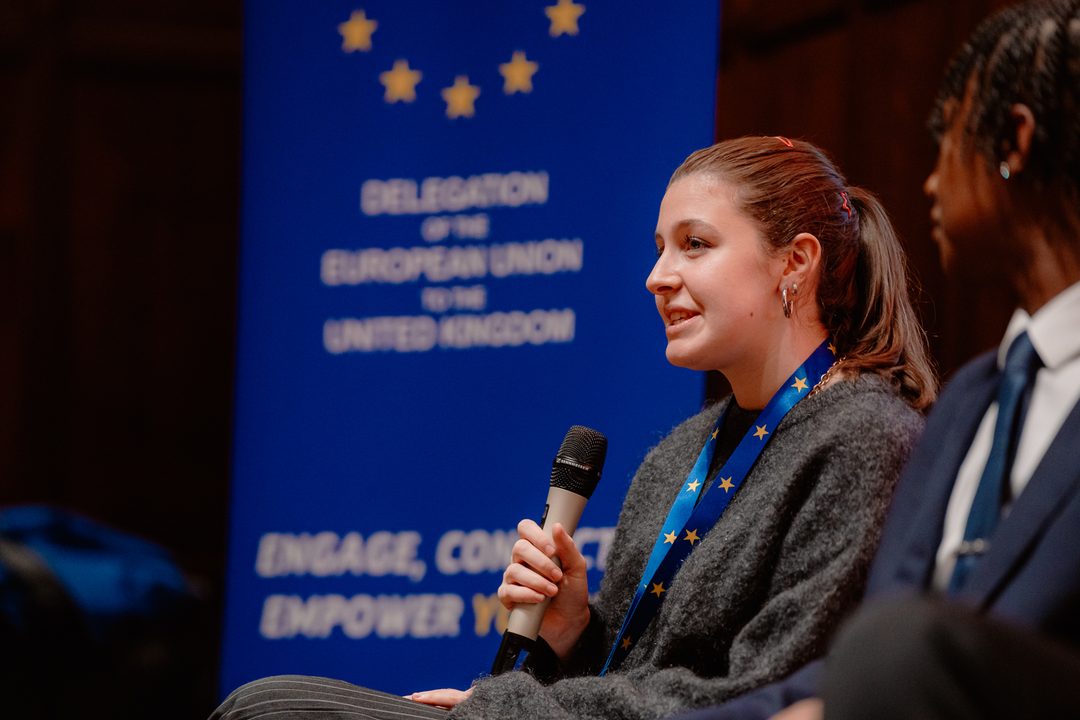 A delegate speaking in front of the EU Delegation banner