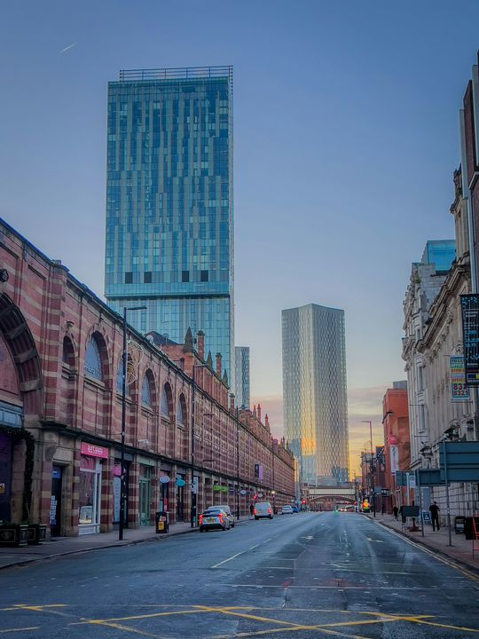 A Manchester street lined with red-brick buildings